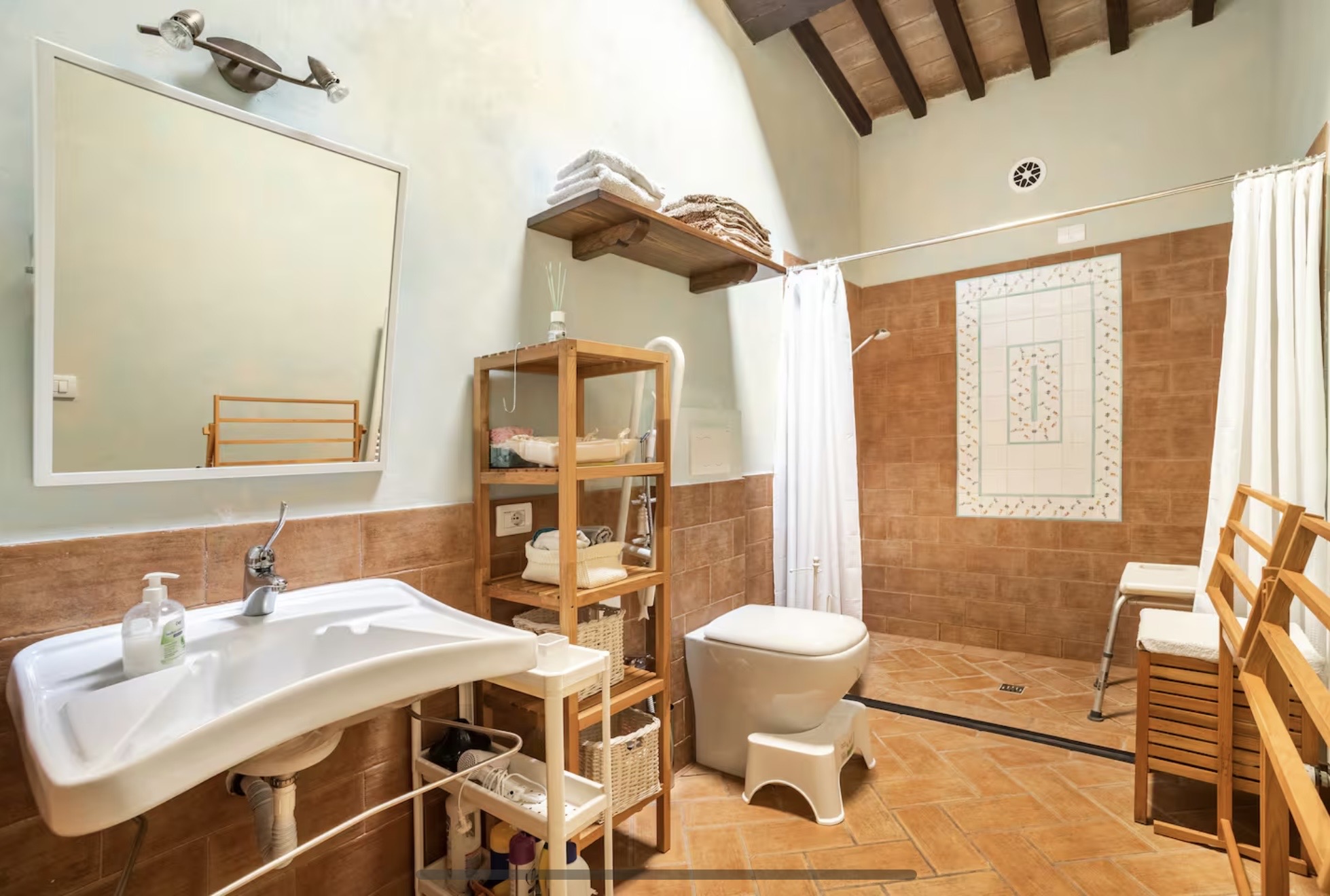 Spacious bathroom with terracotta tiles and walk-in shower