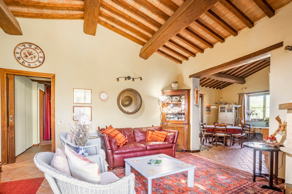 Living room with exposed wooden beams and terracotta floors